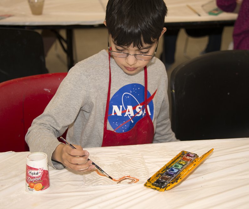 Young student with an art activity