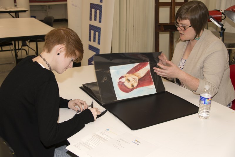 A student receives feedback from artist Megan Mette