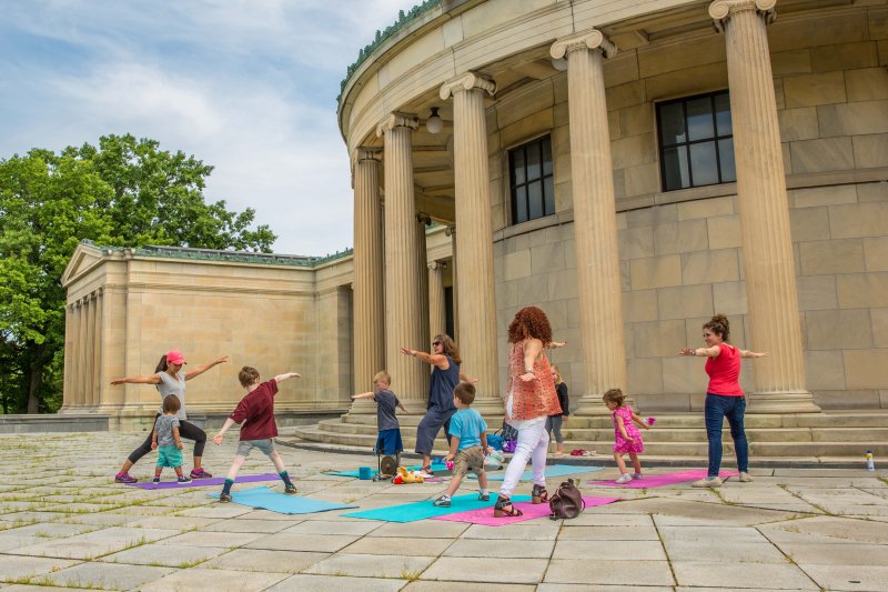 Kids doing yoga on the Elmwood Avenue Portico