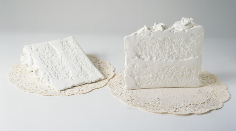 A sculpture of two white pieces of cake