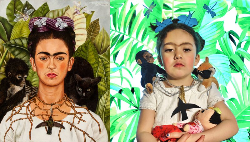 A re-creation of a painting of a Mexican woman with a white shirt, a hummingbird necklace, and two black monkeys on her shoulders