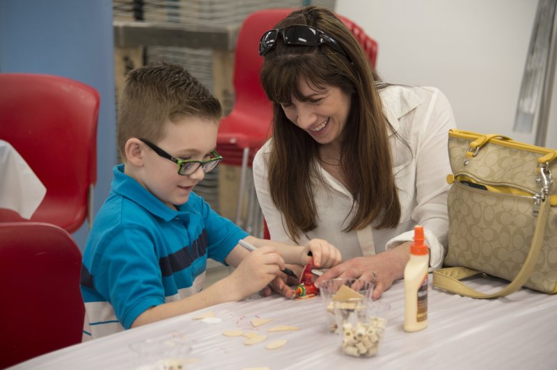 Mother and son making art in the classroom
