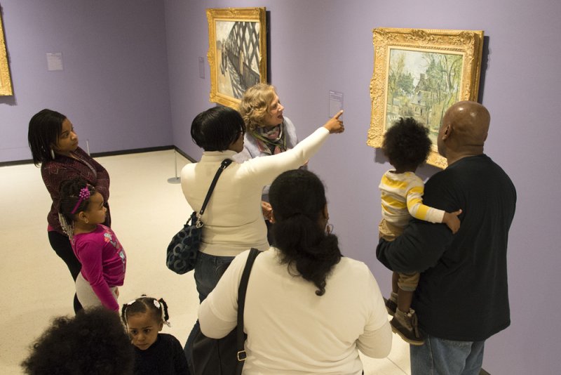 An AK docent leads a public tour