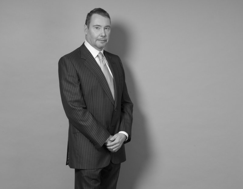 Black and white image of a white man in a business suit