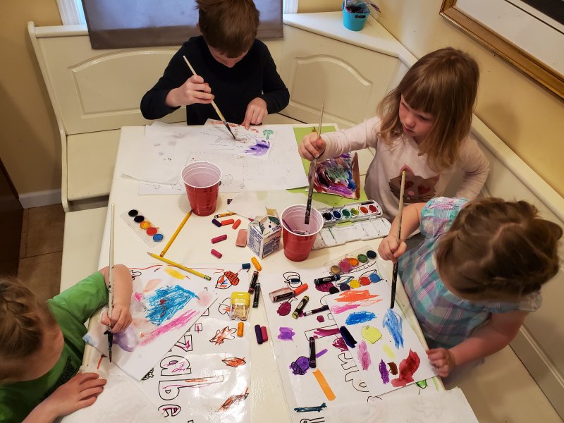 Four white children making art