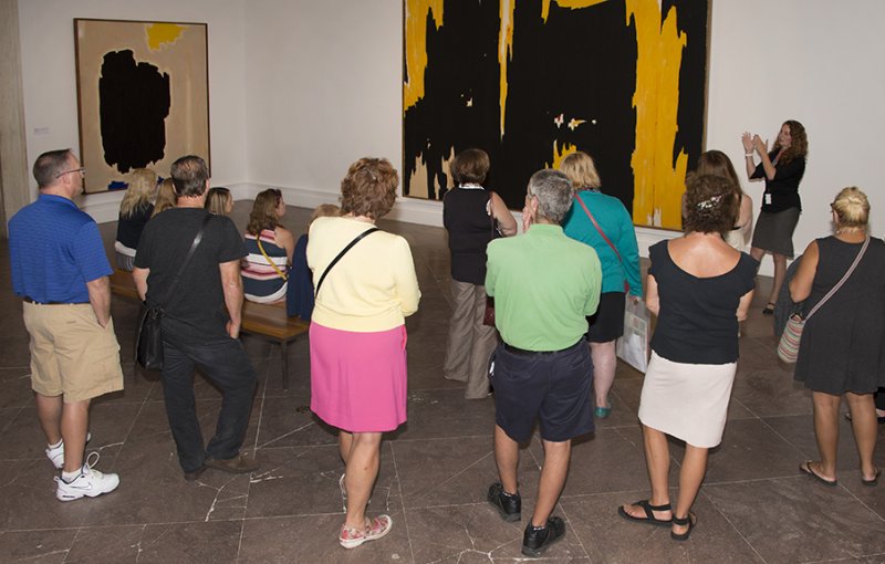 Guests on a tour in front of Clyfford Still's 1957-D-No. 1, 1957
