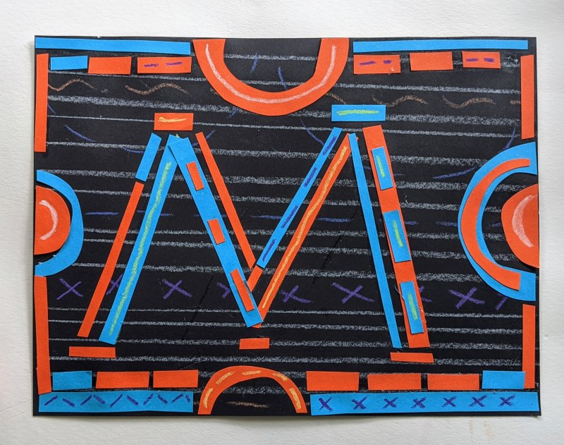 A collage on black paper with the letter "M" made of small strips of red and blue paper