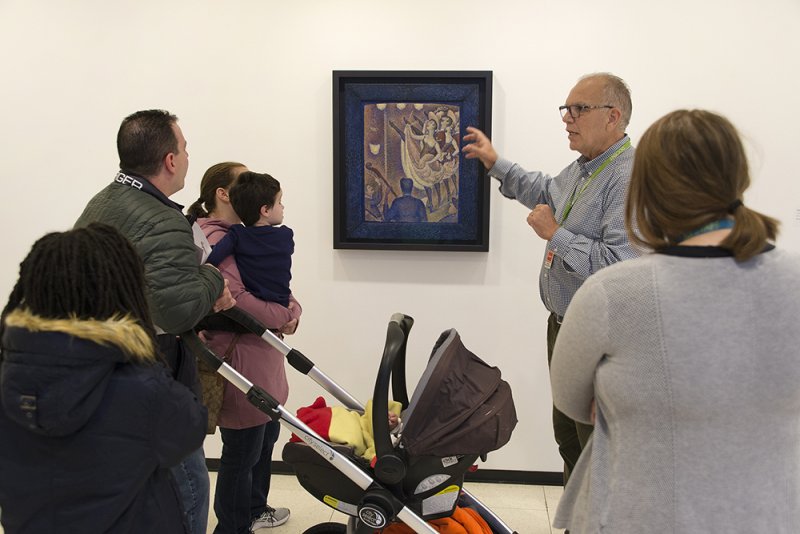 Families on a tour in front of George Seurat's Dance at La Chahut