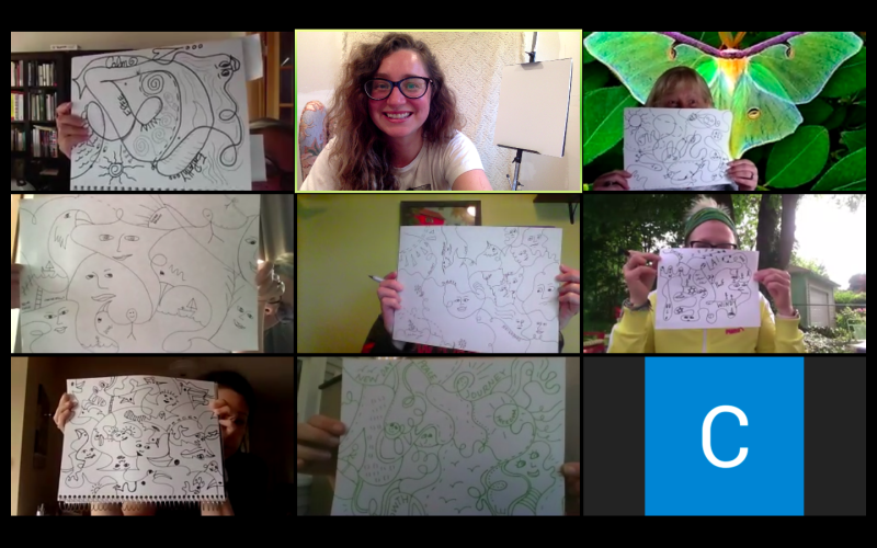 A grid of nine people holding up drawings