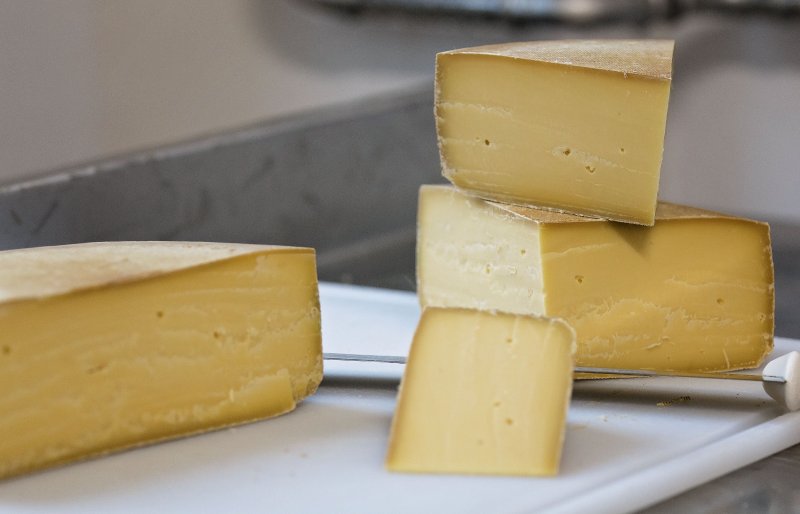 Several pieces of cut cheese stacked on top of each other