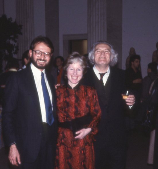 Three people in dress attire smiling for a photo