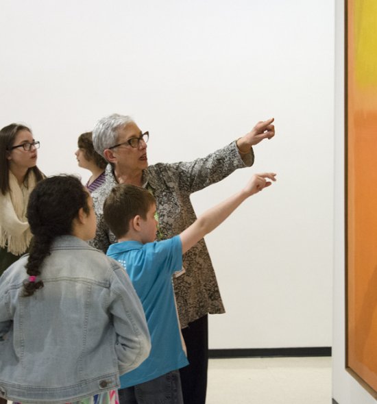 Docent and students with Mark Rothko's Orange and Yellow, 1956