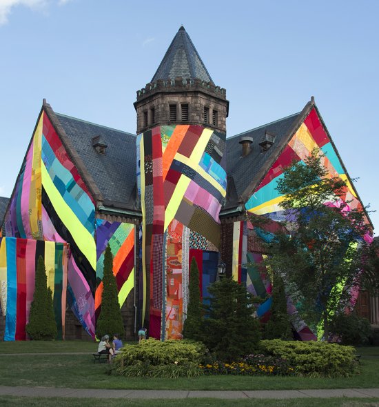 A church covered in swaths of different colored fabric