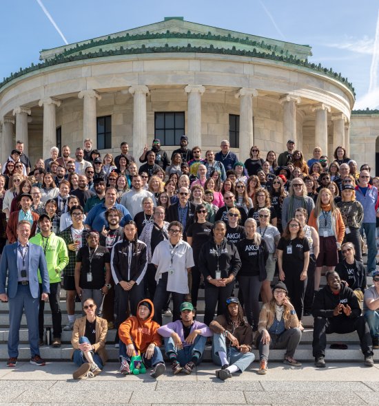 A large group of people posing for a photo on museum steps