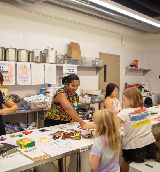 A group of women and girls working on an art project