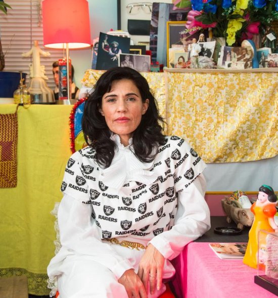 A person sitting in a vibrant art studio