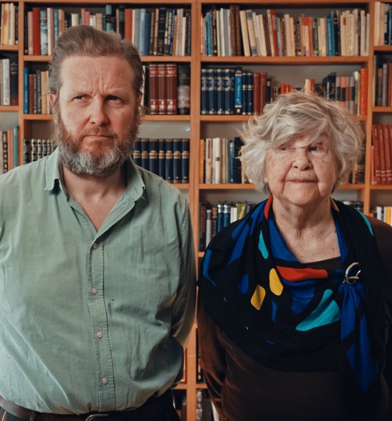 Two people looking forward with stoic expressions
