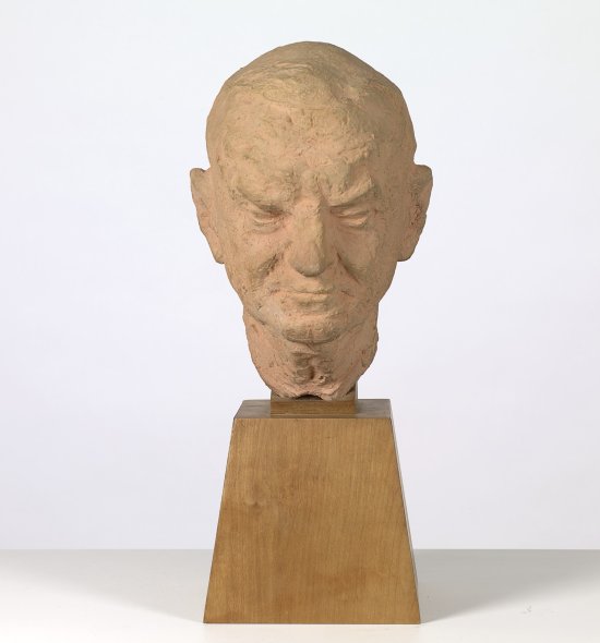 Bust of a man's head on a wooden pedestal