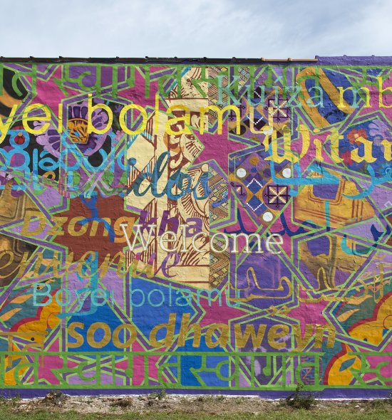 A large mural with the word "welcome" in many different languages