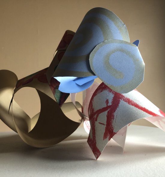 A paper sculpture made up of three different pieces of paper
