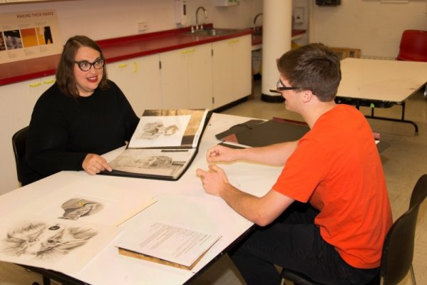A student receives feedback from artist Amy Greenan (left) during the 2015 AK Teens Portfolio Review Day sessions